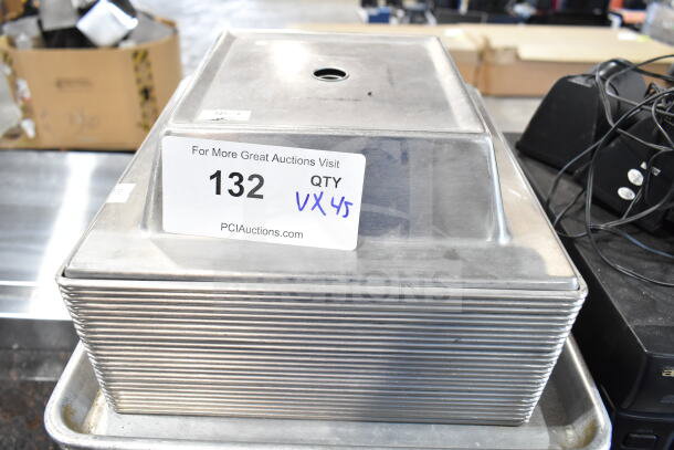 Set of 45 aluminum baking pans in various sizes. Auction label shows item 132, quantity 45, website address.
