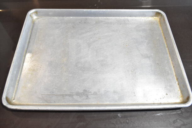 Metal baking pan, pre-owned, showing signs of use with minor scratches and some discoloration. Part of a 45-piece set.