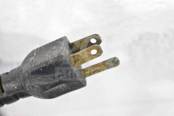 A close-up of a slightly worn electrical plug for the Coldelite Commercial Whipped Cream Dispenser, 115 volts, 1 phase.