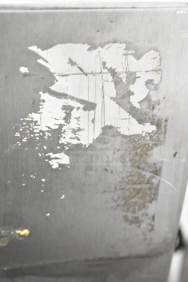 Coldelite commercial countertop whipped cream dispenser, 115 volts, 1 phase. Visible wear on surface, indicating use.