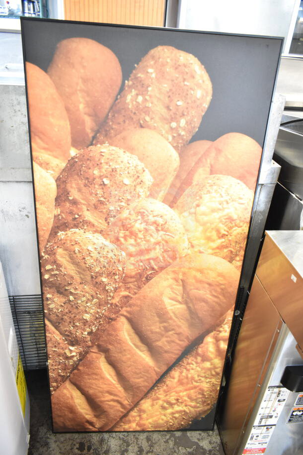 Framed picture of assorted bread loaves with seeds and cheese, vibrant colors, perfect for kitchen decor.
