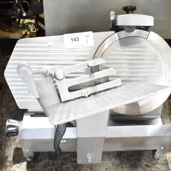 Commercial countertop meat slicer with integrated blade sharpener, 115 volts, 1 phase. Appears in good condition.