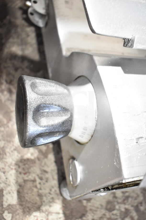Commercial countertop meat slicer with blade sharpener, knob detail; 115 volts, 1 phase, used condition.