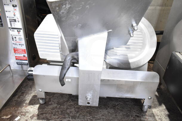 Commercial countertop meat slicer with blade sharpener, 115 volts, 1 phase, stainless steel with visible handle and adjustment knobs.