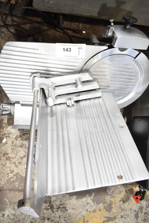 Commercial countertop meat slicer with blade sharpener, 115 volts, 1 phase, in good condition. Auction tag visible.
