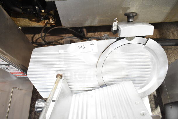 Commercial countertop meat slicer with blade sharpener, 115 volts, 1 phase, silver finish, good condition, auction lot 143.