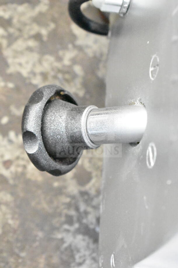 Commercial countertop meat slicer, 115 volts, 1 phase, with blade sharpener. Close-up of adjustment knob and metallic finish.