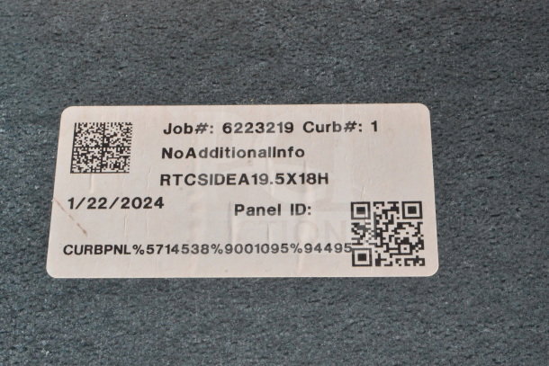 Sticker with job number 6223219, curb number 1, dated 1/22/2024, with QR codes on a rough surface.