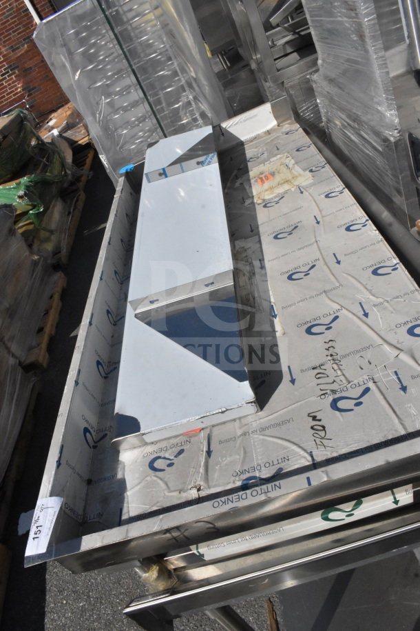 Elkay WT30S69 stainless steel shelf, new condition, with protective wrapping and installation markings visible.