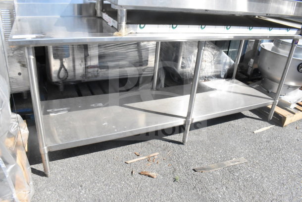 Stainless steel commercial table with under shelf, excellent condition, suitable for kitchen or industrial use.
