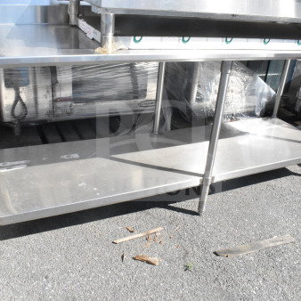 Stainless steel commercial table with under shelf, excellent condition, suitable for kitchen or industrial use.