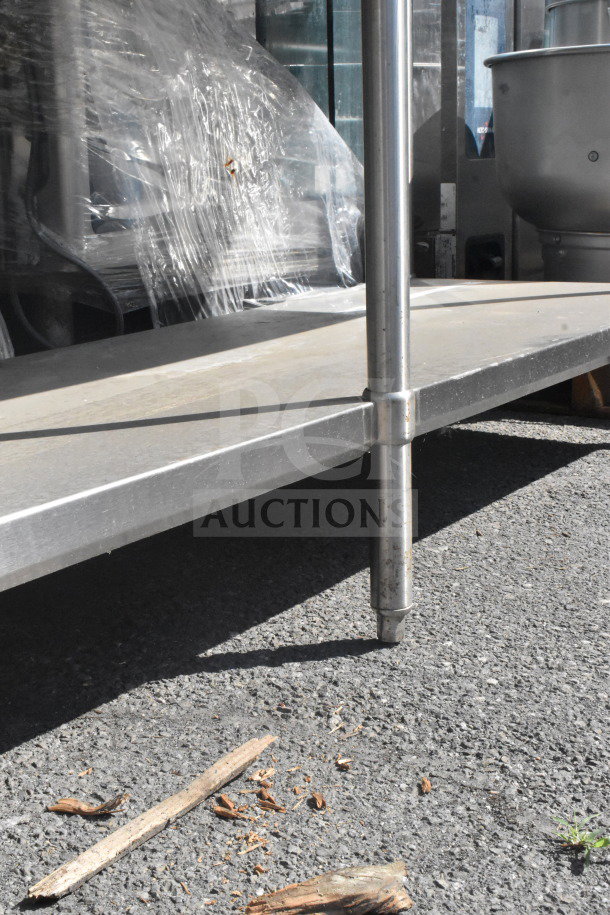 Commercial stainless steel table with under shelf, durable construction, sturdy legs, suitable for kitchen or restaurant use.