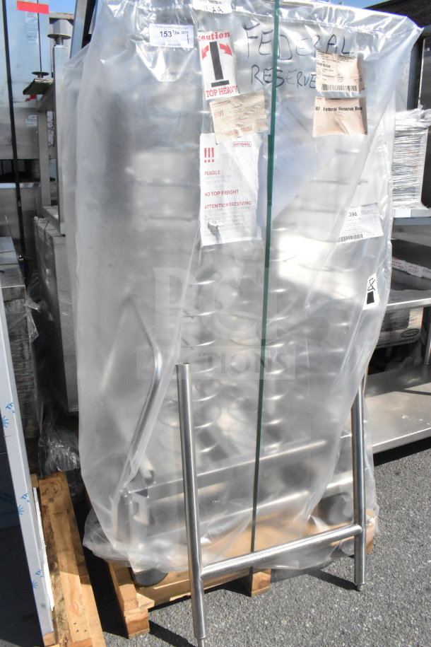 Rational HGW202 WA55 commercial roll-in rack, on casters, covered in protective plastic with caution labels visible.