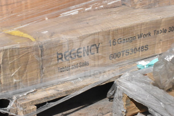 Brand new Regency 600TS3048S 16-gauge work table packaging, showcasing label details on wooden pallet.