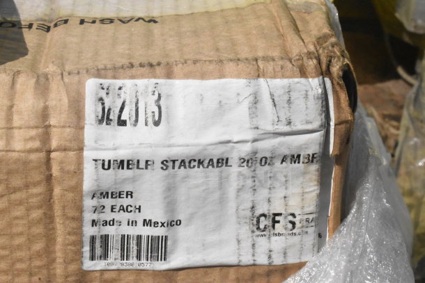 Cardboard box labeled "TUMBLR STACKABLE 20 OZ. AMBER, 72 EACH, Made in Mexico." Slight wear visible on packaging.