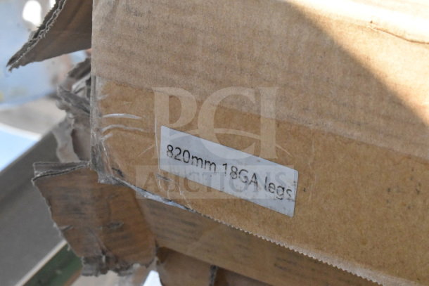 Cardboard box with visible label stating "820mm 18GA legs." Box shows signs of damage, likely from scratch and dent items.
