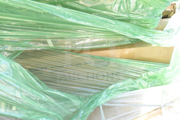 Regency 16-gauge work table wrapped in green plastic. Label shows model 30x48, part SN#73048G. Brand new condition.