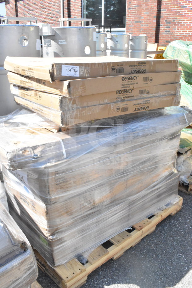 Shrink-wrapped pallet of 12 brand new scratch and dent items, including Regency shelves. Boxes show minor wear.
