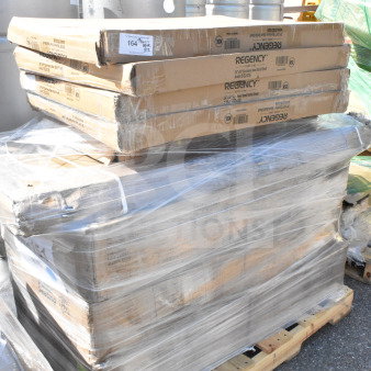 Shrink-wrapped pallet of 12 brand new scratch and dent items, including Regency shelves. Boxes show minor wear.