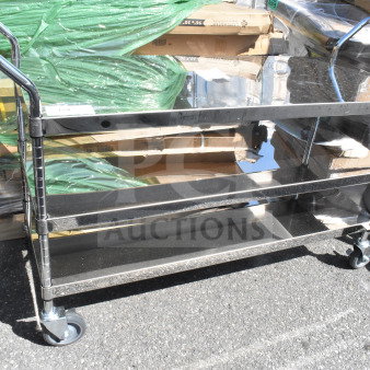 3 tier metal cart on commercial casters, polished steel, durable construction, dual handles, excellent condition.