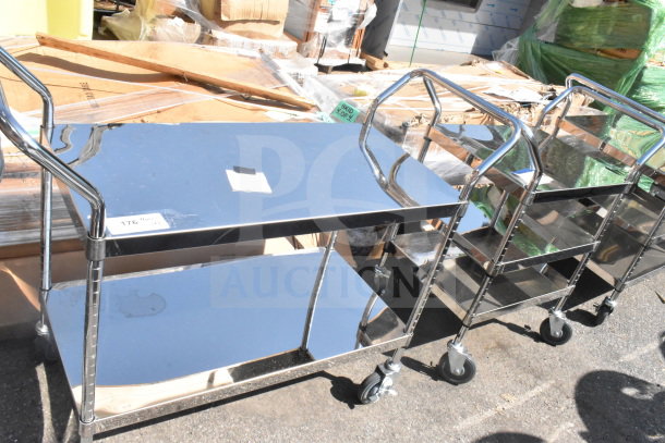 2 stainless steel utility carts: one 2-tier and one 3-tier, both on commercial casters, in good condition. Auction item.