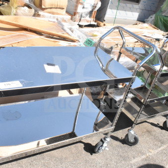 2 stainless steel utility carts: one 2-tier and one 3-tier, both on commercial casters, in good condition. Auction item.