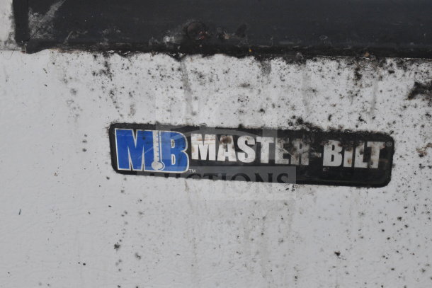 Master-Bilt commercial ice cream dipping cabinet with visible logo, showing wear and dirt accumulation.