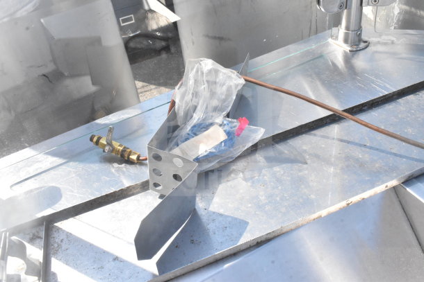 Counter with bay and sneeze guard, stainless steel, additional components visible, used condition.