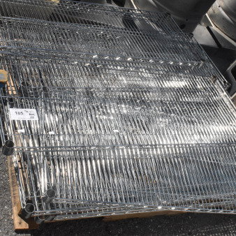 Lot of 18 chrome finish wire shelves, shiny condition, stacked on a pallet. Label indicates item number "185."