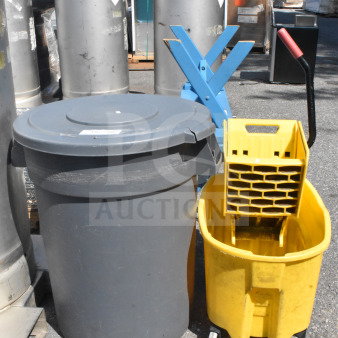 Gray trash can with lid and yellow mop bucket with wringer. Outdoor setting, items appear used. No visible markings.