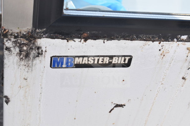 Master-Bilt Commercial Ice Cream Dipping Cabinet with visible wear. Brand logo displayed; exterior shows signs of use.