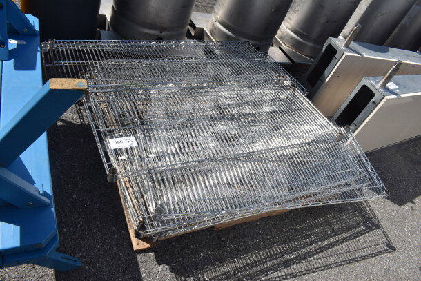 Lot of 18 chrome finish wire shelves on a pallet, in good condition. White label marked "185" is visible.