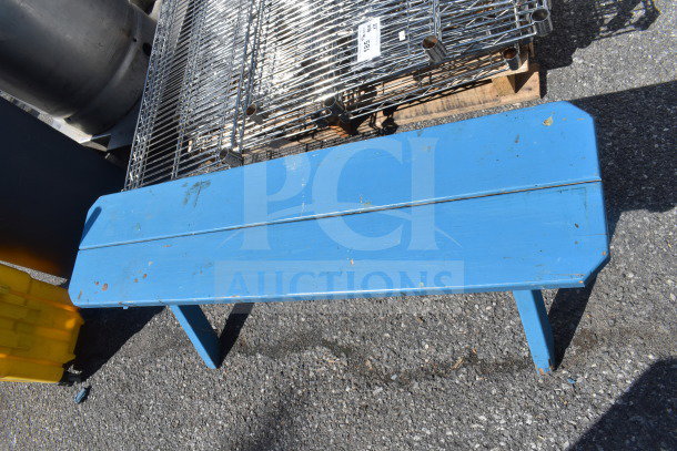 Blue wooden bench with slight wear and paint scuffs, metal structure visible beneath; auction item "2 Blue Bench."