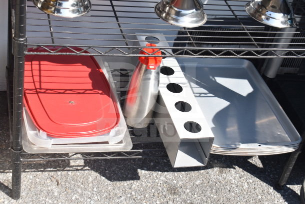 Black 5-tier wire shelving unit with contents. Features red-lidded containers, stainless steel items, and metal trays. Buyer must dismantle.