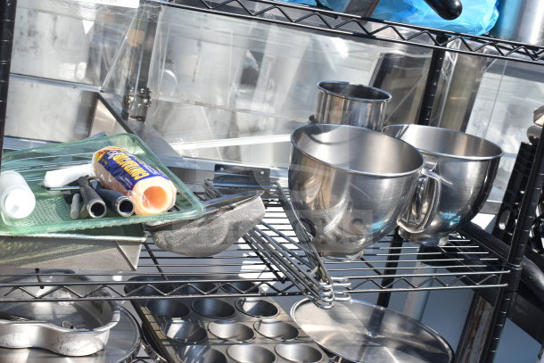 Black 5-tier wire shelving unit with kitchen items, including mixing bowls and pans. Buyer must dismantle. Consider freight.