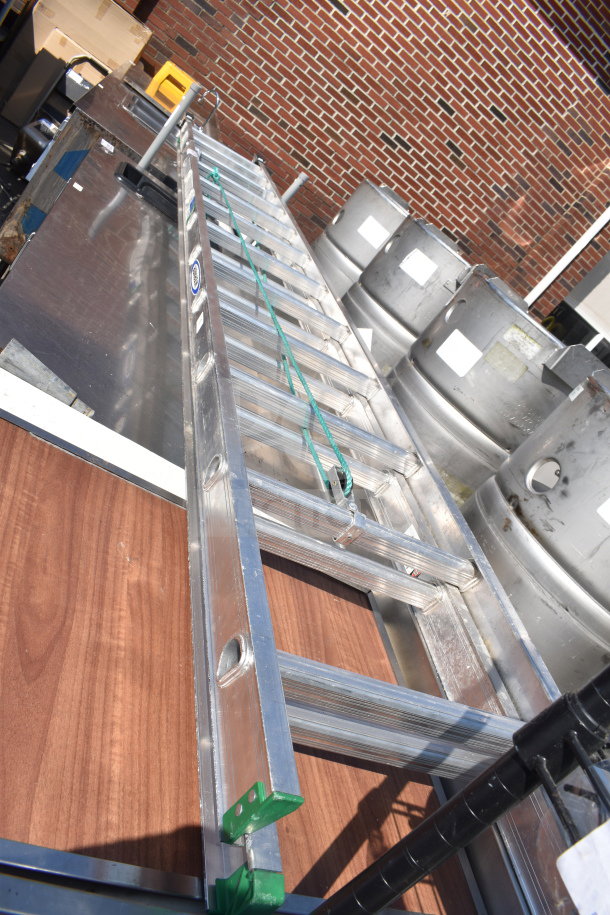 Werner 24' flat ladder, 225 lb capacity, aluminum, good condition, visible labels, green safety foot caps.