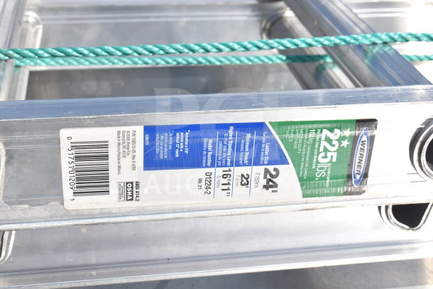 Werner 24' aluminum ladder, 225 lb capacity, flat design. Includes visible labels with model number and safety standards.