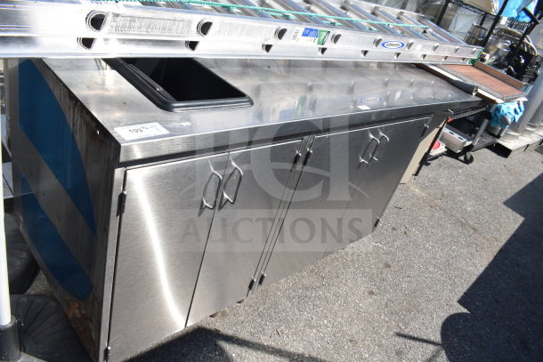 Commercial stainless steel counter with four doors, visible signs of wear, ideal for kitchen use, numbered tag 193.