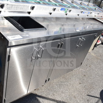Commercial stainless steel counter with four doors, visible signs of wear, ideal for kitchen use, numbered tag 193.
