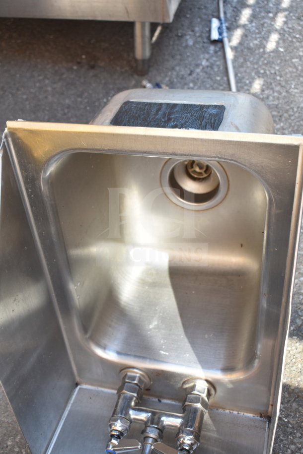 Stainless steel single bay wall mount sink with faucet, good condition, includes visible drain and dual water controls.
