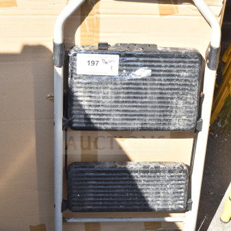 Sturdy A-frame ladder with textured black steps, used condition. Label reads "197, 7/10 QTY." Ideal for household use.