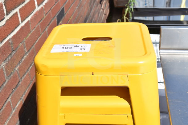 4 yellow Tolix style stools, stackable, with handhold design. Includes label "193, QTY X4" indicating auction lot details.