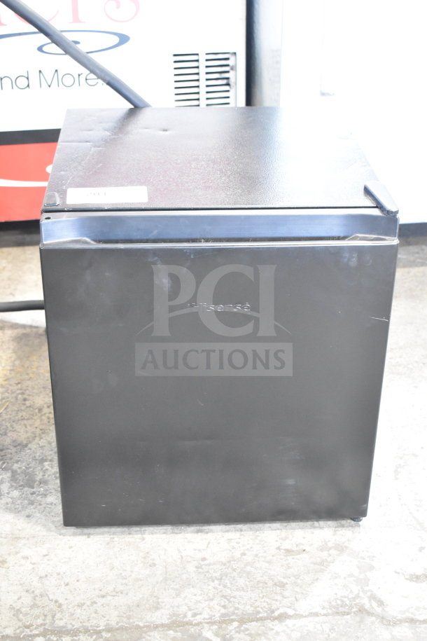 Hisense 32KHS310986 mini cooler, black, 115 volts, 1 phase. Minor exterior wear, model tag visible on top.