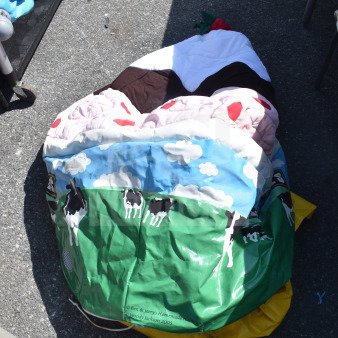 Lot of items including a Ben & Jerry's branded inflatable with cow print, Slim Jim trash can included, fair condition.