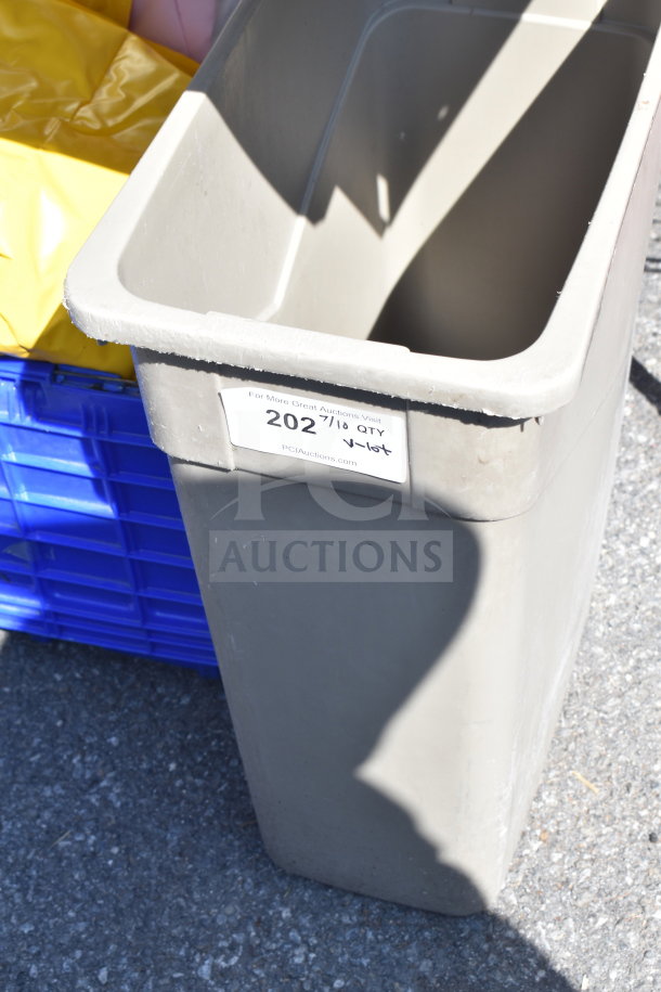 Gray Slim Jim trash can with visible label, part of a mixed auction lot including various items like a costume.