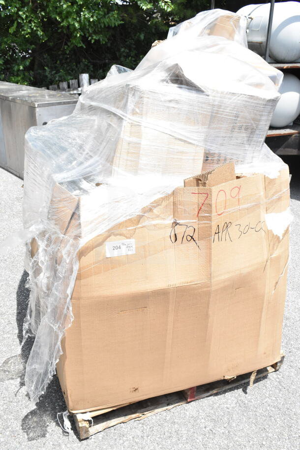 Bundle of 21 new scratch and dent items, including towels and fry cutter, on a pallet. Visible labels indicate auction details.