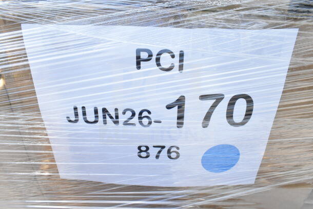 Stacked pallet of brand new scratch and dent items including cold cups, napkins, hot cups, wrapped in plastic, labeled JUN26-170.