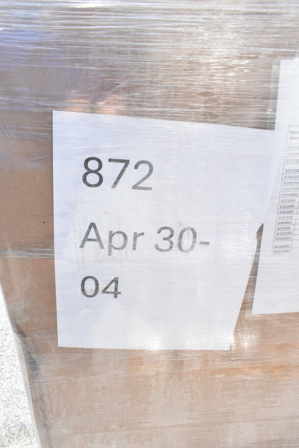 Plastic-wrapped pallet labeled "872 Apr 30-04," containing 18 new scratch and dent items including towel dispenser, hot cups, tumblers.