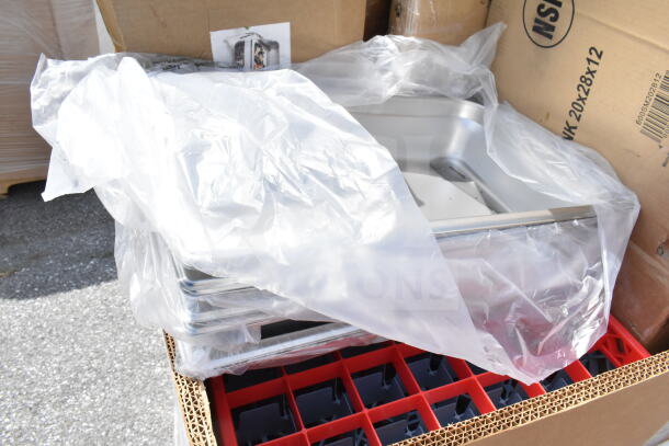 12 new scratch and dent items, including mop sink and utility cart, partially unboxed with protective plastic wrap.