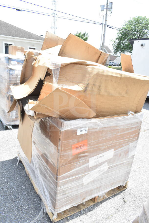 Pallet with wrapped cardboard boxes labeled "217" and "CHICKEN," indicating scratch and dent auction items including chafer and bussing cart.